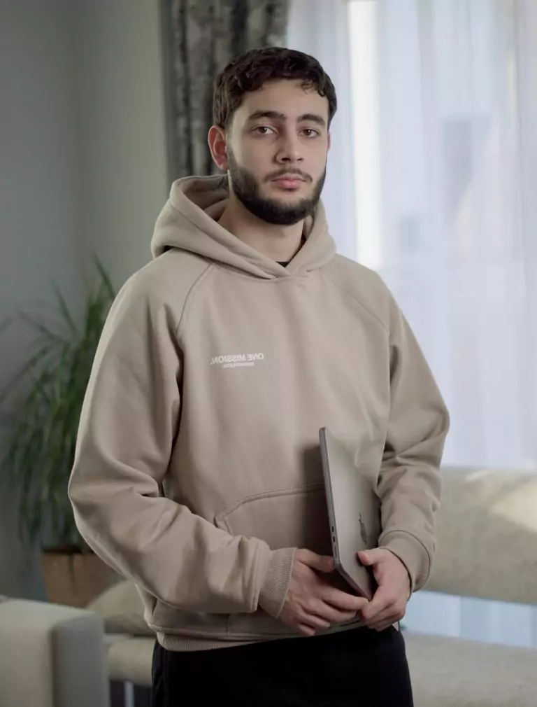 a man holding a laptop